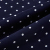 View 3 of product The Navy and White Spotted Silk Scarf by Turnbull & Asser features white polka dots, a fringed edge, and the brand's name printed near the bottom on both sides. It is neatly folded at the top.