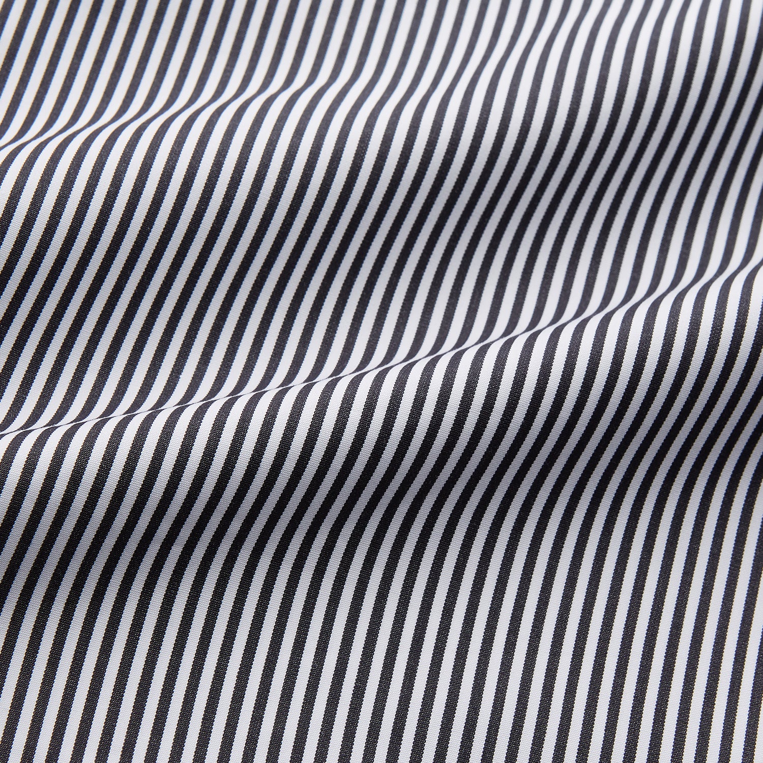 View 2 of product The Turnbull & Asser Black Candy Stripe Cotton Hyde Pyjama Set for men features soft cotton striped pajamas with a long-sleeve, button-up shirt detailed with black piping and three pockets, plus matching pants, both laid flat on a white background.