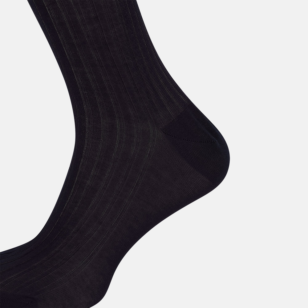 A single Midnight Mid-length Sock by Turnbull & Asser, made from mercerised Egyptian cotton, stands upright on a white background. This luxury black sock features a ribbed texture with smooth toe and heel areas.
