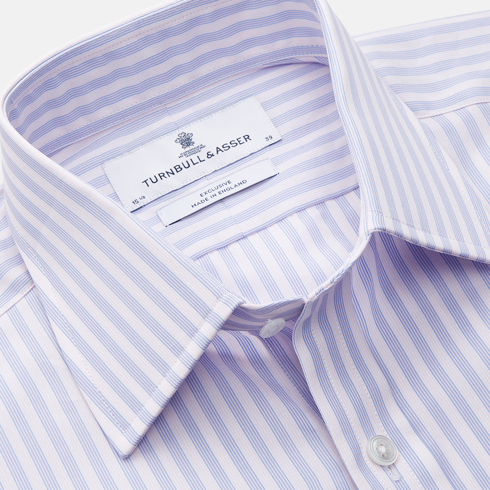 The Turnbull & Asser Lilac Stripe Cotton Regular Fit Mayfair Shirt features thin white and lilac stripes, a T&A collar, and buttoned cuffs, shown laid flat on a white background.