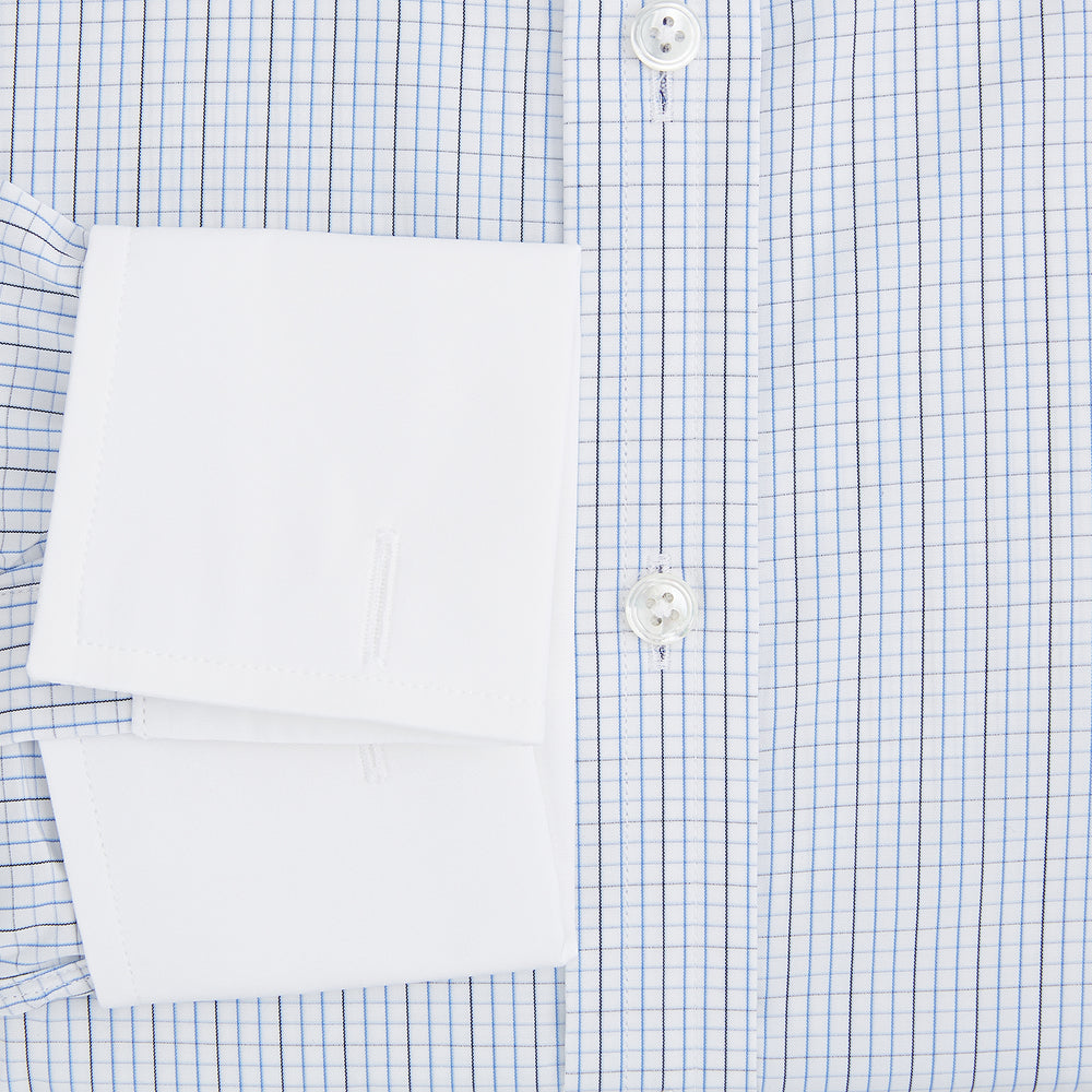 The Turnbull & Asser Pale Blue and Navy Grid Check Shirt features a contrast T&A collar and cuffs, long sleeves, and a button-down front, all displayed on a plain white background.