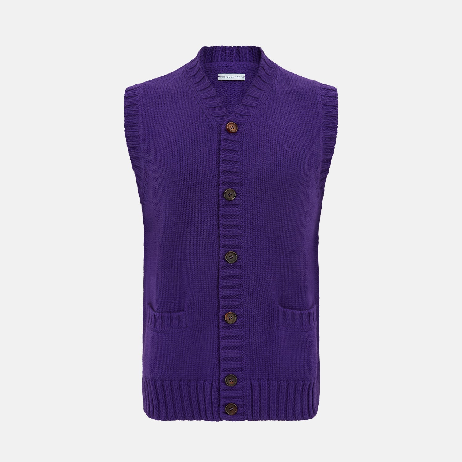 View 1 of product The Turnbull & Asser Purple Merino V-Neck Sleeveless Cardigan features a ribbed collar, button-down front, and two pockets—a refined light layer for gentlemen—shown on a plain white background.
