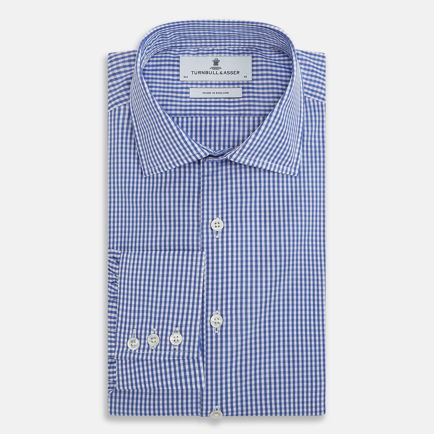 View 5 of product The Turnbull & Asser Blue Grid Check Belgravia Shirt, made from pure cotton with long sleeves, a spread collar, buttoned cuffs, and a blue-and-white check pattern, is laid flat on a white background.