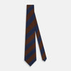 View 2 of product A close-up of the Turnbull & Asser Brown and Navy Block Stripe Silk Tie displays its textured pattern with classic suiting diagonal stripes in navy blue and brown on a light background.