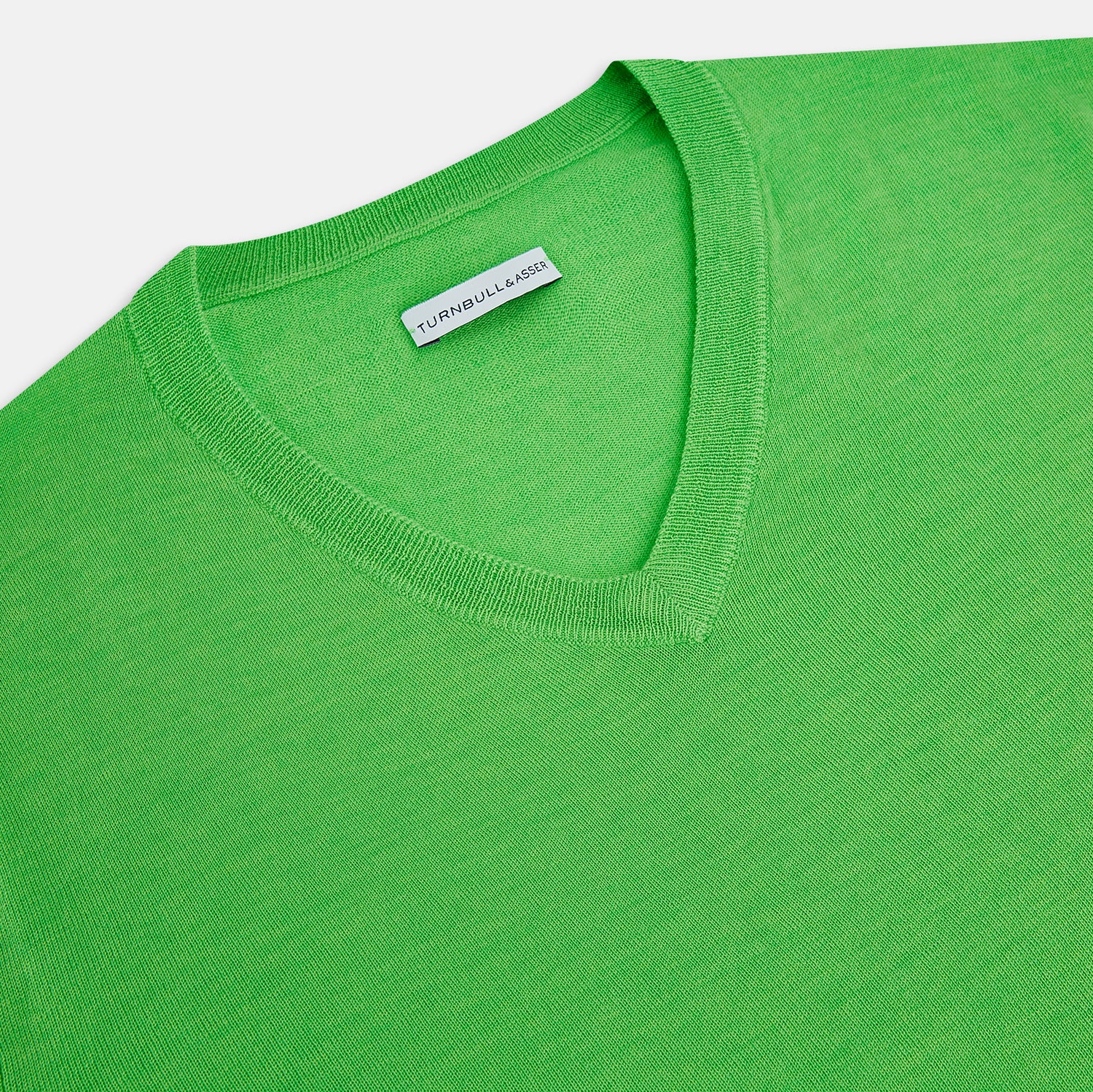 View 2 of product The Turnbull & Asser Lime Green Fine Merino V-Neck Jumper features ribbed cuffs and hem—a vibrant, standout knitwear choice for any wardrobe.