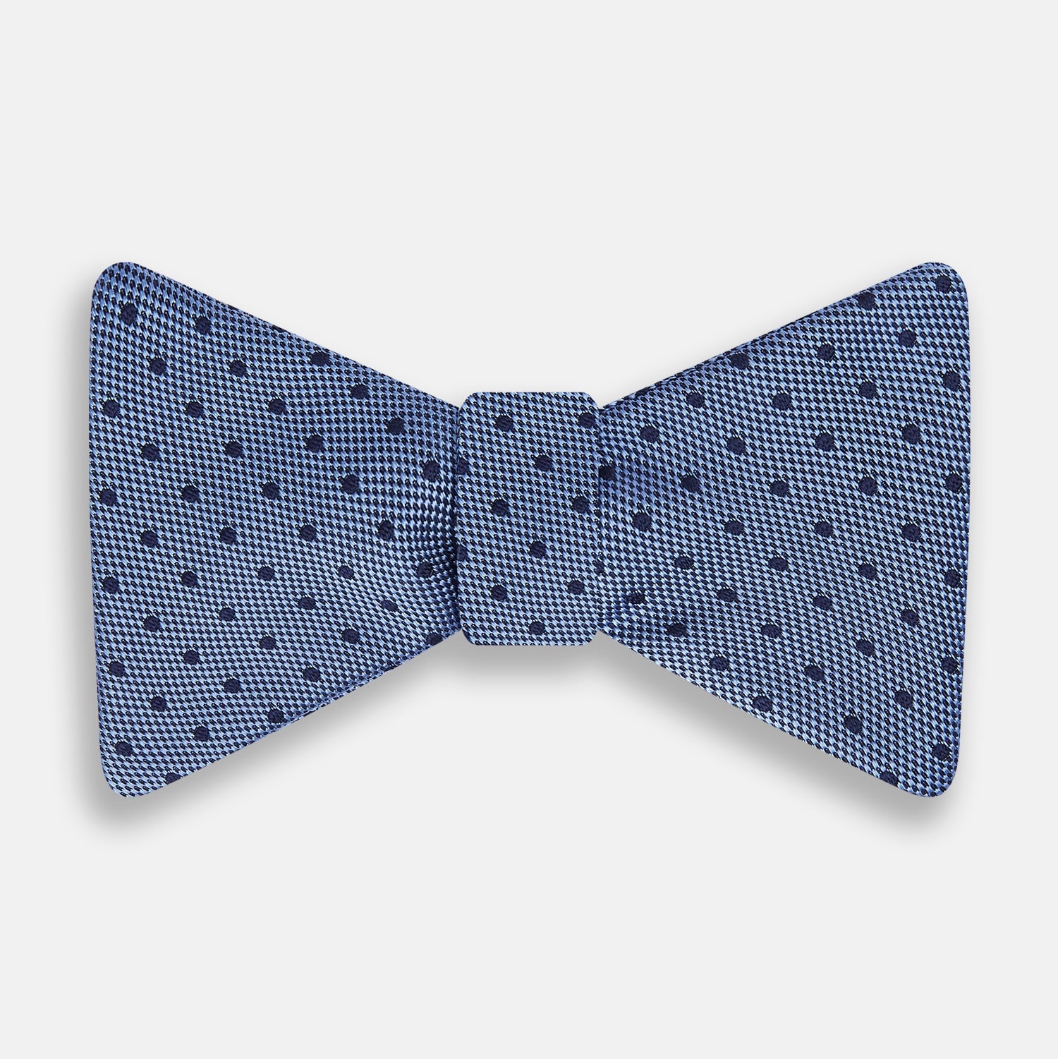 View 1 of product The Turnbull & Asser Blue Micro Dot Silk Bow Tie features a subtle textured pattern with small navy polka dots, shown on a white background—an ideal accessory for smart attire.