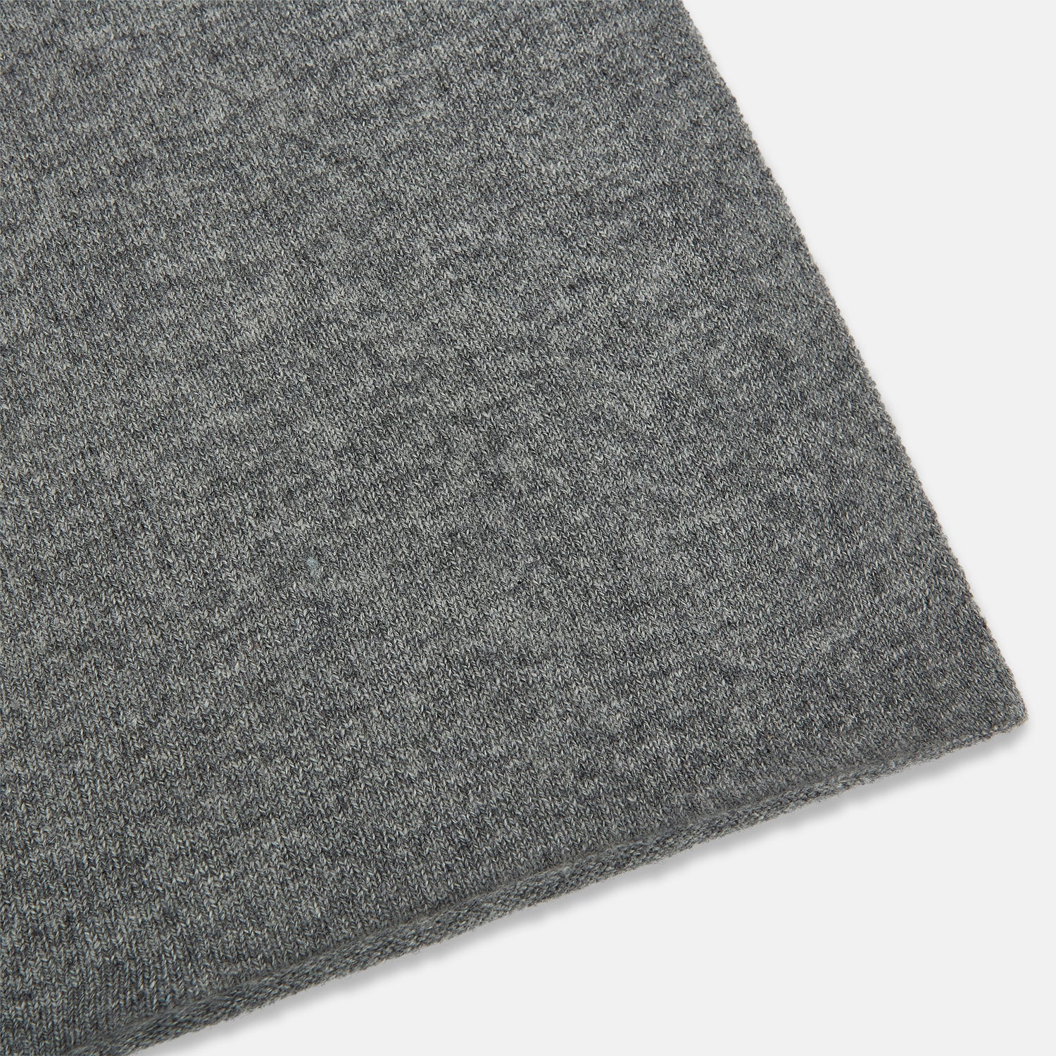View 2 of product The Turnbull & Asser Plain Grey Cashmere Knitted Scarf is shown draped against a white background, highlighting its soft luxury and timeless appeal.