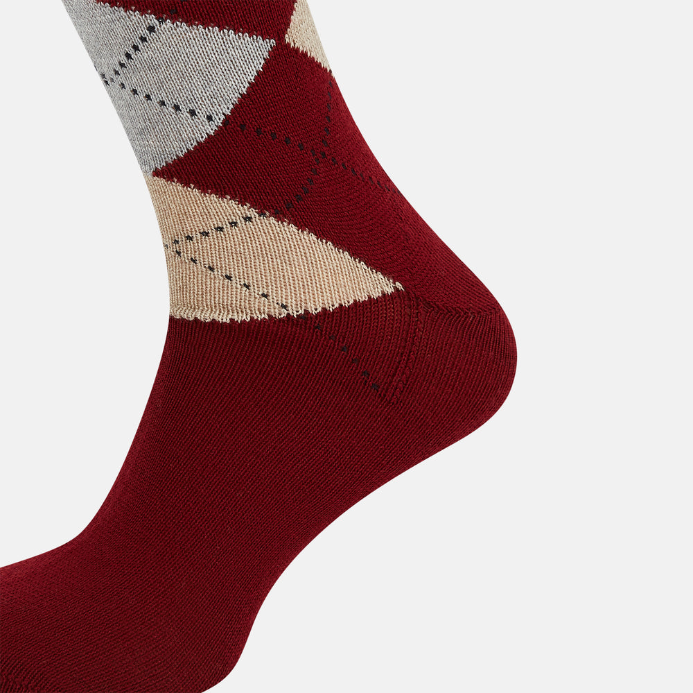The Turnbull & Asser Burgundy Wool Check Mid-Length Sock features a dark red base with beige, white, and light brown argyle diamonds on the calf, shown against a plain white background.
