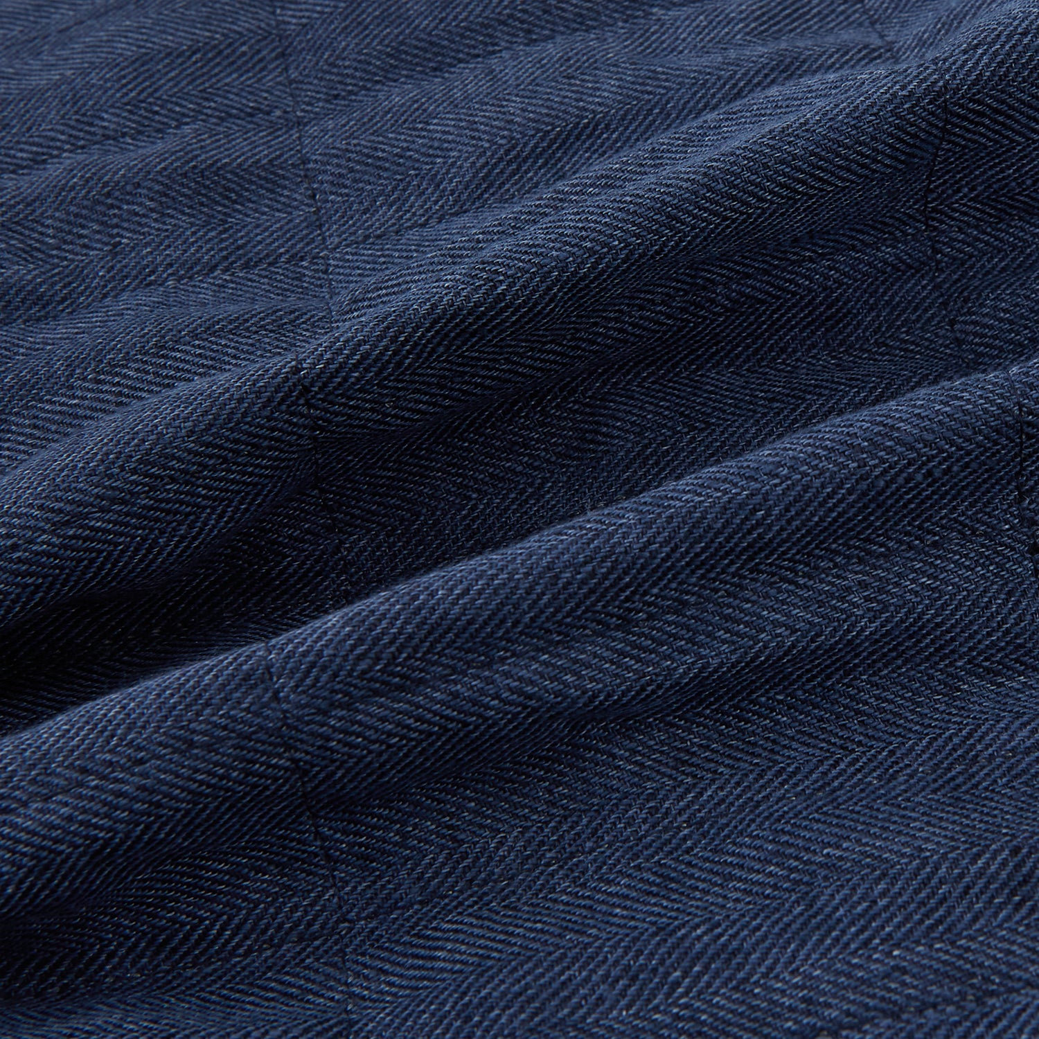 View 5 of product The Denim Blue Quilted Linen Herringbone Waistcoat by Turnbull & Asser features a sleeveless design, five black buttons, two zippered side pockets, and a small chest pocket against a plain white background.