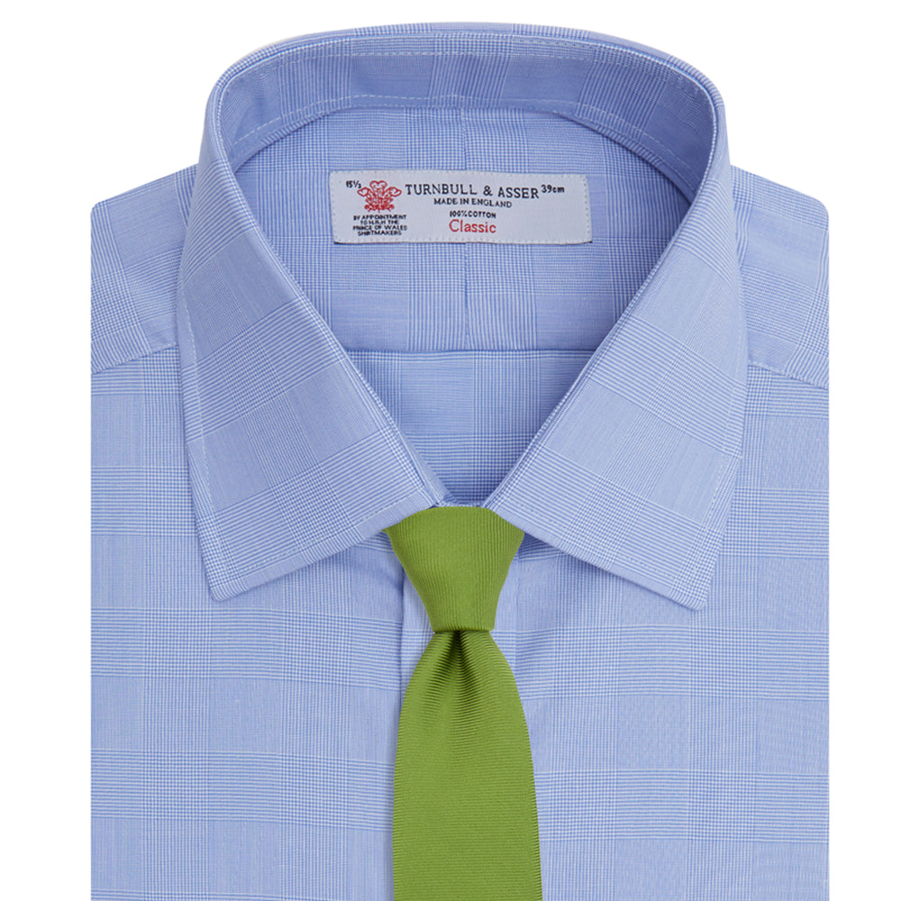 A Blue Prince of Wales Check Shirt by Turnbull & Asser, featuring a T&A collar and 3-button cuffs, is neatly folded and displayed on a plain white background.