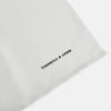 View 2 of product The Turnbull & Asser White Silk Scarf features fringed edges and discreet black branding in the corner, making it a refined accessory for tuxedo jackets or formal wear. Presented neatly folded on a plain white background.