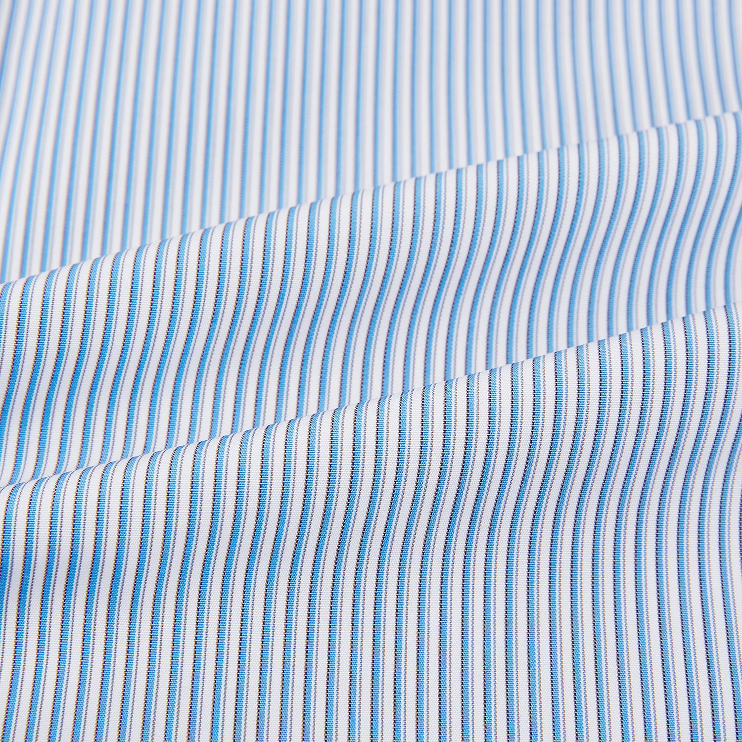 View 6 of product The Turnbull & Asser Pale Blue Pinstripe Mayfair Shirt features pale blue pinstripes, a classic T&A collar, white buttons, and cuffed sleeves, shown against a plain white background.