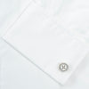 View 6 of product A Turnbull & Asser Two-Fold 200 White Cotton Shirt with T&A collar and double cuffs, neatly folded to show the label inside the collar, is displayed on a light blue background.