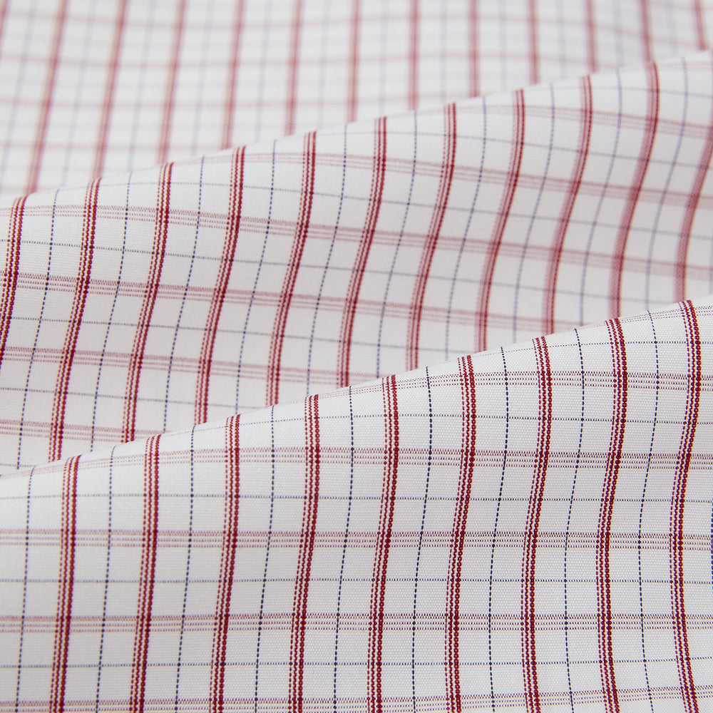The Turnbull & Asser Red Tattersall Check Mayfair Shirt features long sleeves, a collar, and Italian cotton with a red tattersall check on white, shown flat against a white background.
