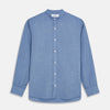 View 1 of product The Turnbull & Asser Blue Cotton Weekend Fit Blake Shirt features a light blue color, long sleeves, stand collar, white buttons, and a curved hem—ideal for casual weekends. Laid flat on a white background.