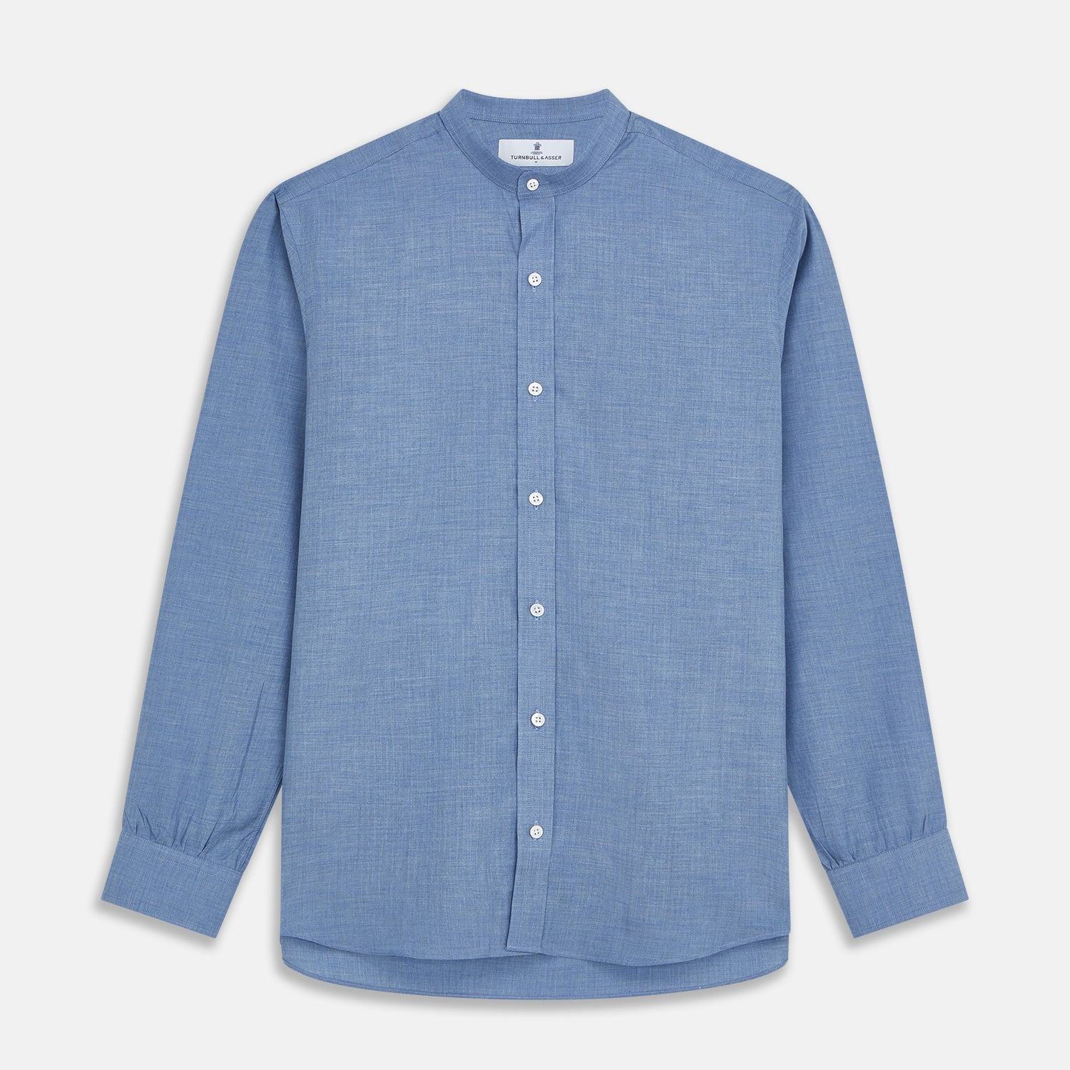 View 1 of product The Turnbull & Asser Blue Cotton Weekend Fit Blake Shirt features a light blue color, long sleeves, stand collar, white buttons, and a curved hem—ideal for casual weekends. Laid flat on a white background.