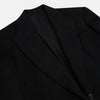 View 2 of product The Turnbull & Asser Black Morning Coat features satin peak lapels, a single front button closure, and long sleeves, shown against a plain white background.