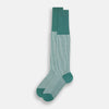 View 2 of product Turnbull & Asser Melon Green/White Thin Striped Long Sock features melon green and white vertical stripes with a solid green toe, heel, and cuff, shown singly against a plain light background.