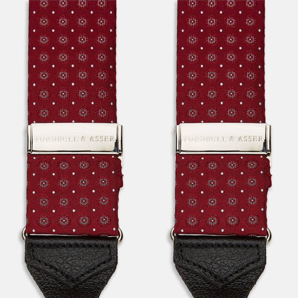The Turnbull & Asser Burgundy Assorted Braces feature small white dots, silver adjusters, and black leather loops—a timeless accessory for the traditional gentleman.