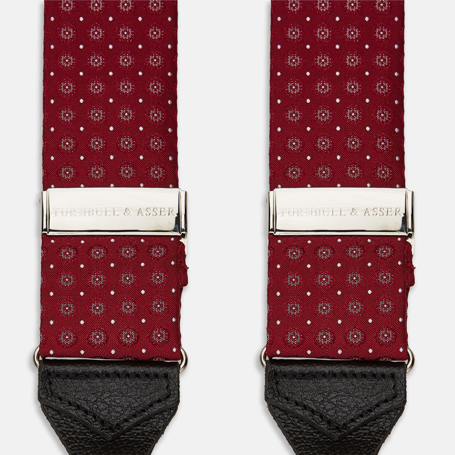View 2 of product The Turnbull & Asser Burgundy Assorted Braces feature small white dots, silver adjusters, and black leather loops—a timeless accessory for the traditional gentleman.