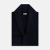 View 4 of product The Turnbull & Asser Midnight Blue Cashmere Shawl Collar Cardigan features ribbed fabric, five black front buttons, a shawl collar, and two front patch pockets, shown against a plain light background.