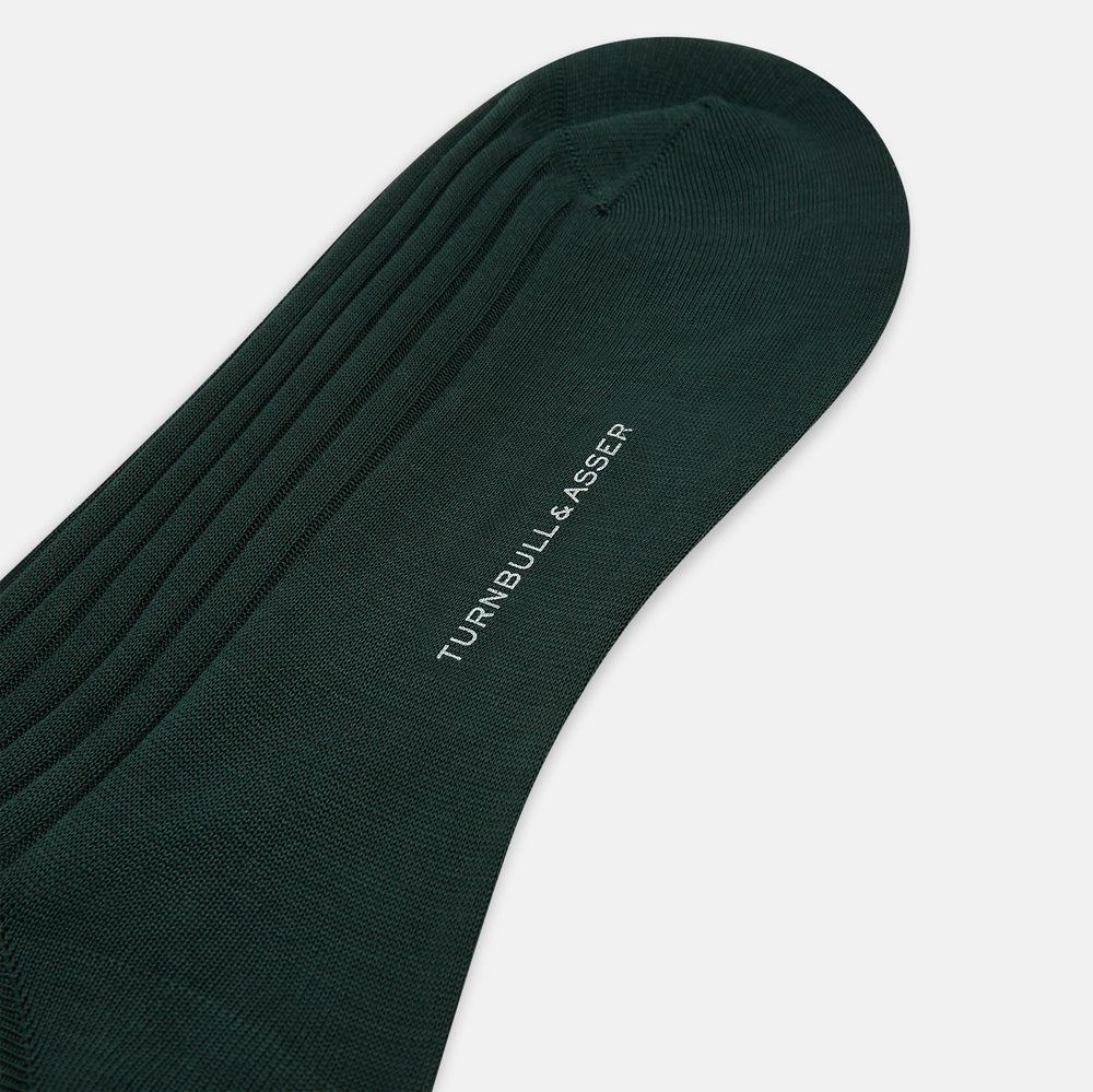 The Turnbull & Asser Olive Long Socks, featuring a ribbed texture, are shown over the calf on a plain white background—a refined addition to any men’s dress sock collection.