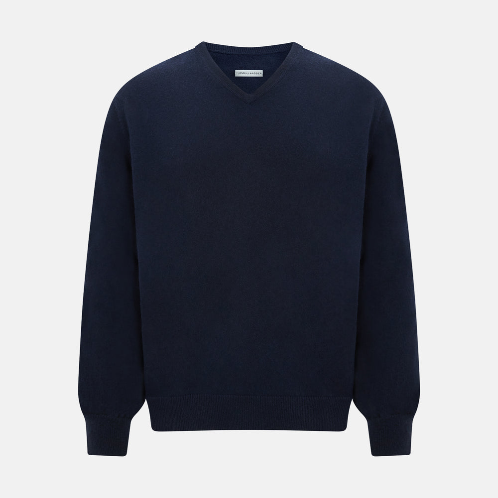 The Turnbull & Asser Navy Cashmere V-neck Jumper features long sleeves with ribbed cuffs and hem, shown against a white background.