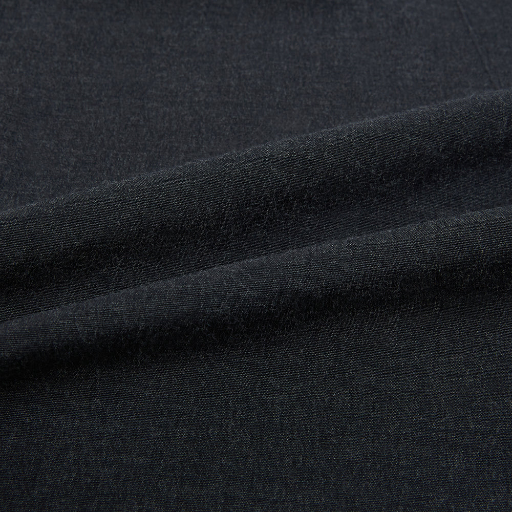 The Turnbull & Asser Midnight Blue Westminster Shirt features long sleeves, a button-up front, classic collar, and buttoned cuffs in a plain design—showcasing British craftsmanship—laid flat on a white background.