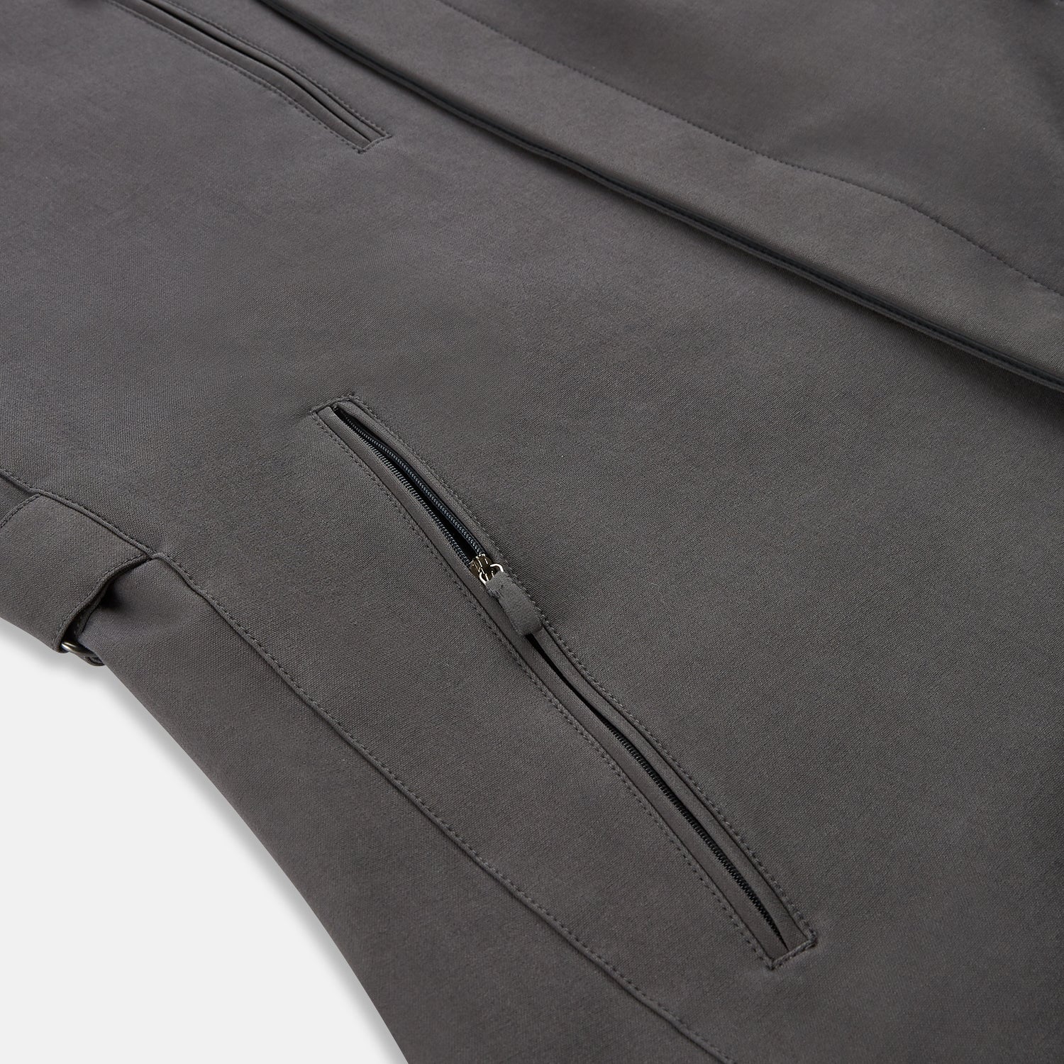 View 6 of product The Turnbull & Asser Charcoal Melange John Arthur Trench Coat, featuring a collar, single-breasted closure, and three zippered pockets—one chest and two at the hips—is shown against a plain white background.