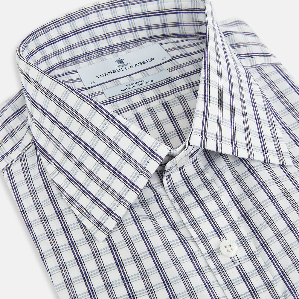 The Turnbull & Asser Purple Multi Check Mayfair Shirt is a long-sleeved, button-up cotton shirt with a collar and purple check pattern, perfect for formal wear and shown against a plain white background.