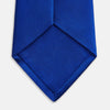 View 4 of product The Turnbull & Asser SATIN CRUISE TIE, in vibrant royal blue with a smooth, lustrous finish, creates a striking contrast against a plain white background.