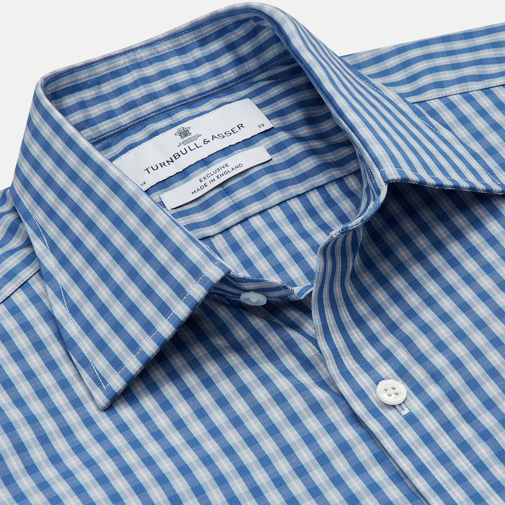 The Turnbull & Asser Navy Multi Check Cotton Regular Fit Mayfair Shirt features long sleeves, button-down front, collar, and buttoned cuffs in a navy and white check pattern, shown against a plain white background.