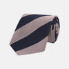 View 1 of product The Turnbull & Asser Navy and Rose Block Stripe Repp Silk Tie, crafted from luxurious silk, features bold diagonal stripes and is displayed rolled up on a plain white background.