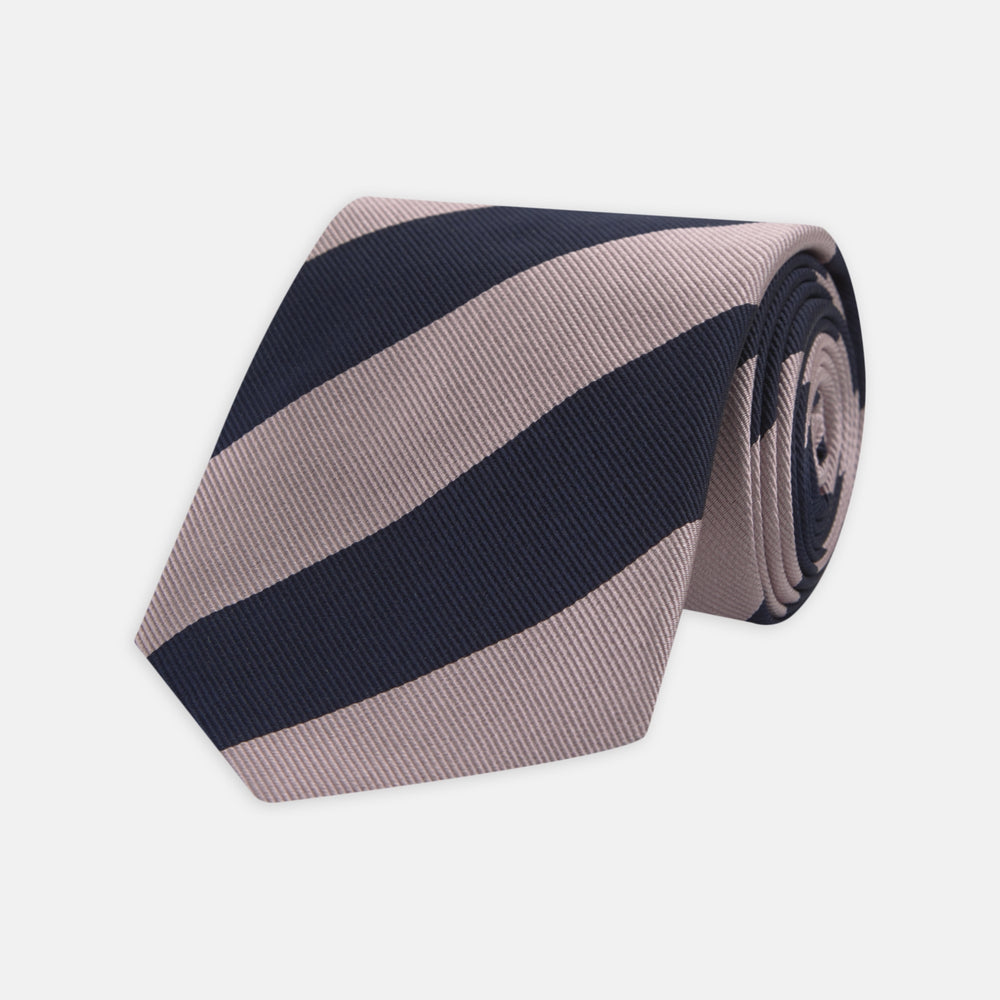 The Turnbull & Asser Navy and Rose Block Stripe Repp Silk Tie, crafted from luxurious silk, features bold diagonal stripes and is displayed rolled up on a plain white background.