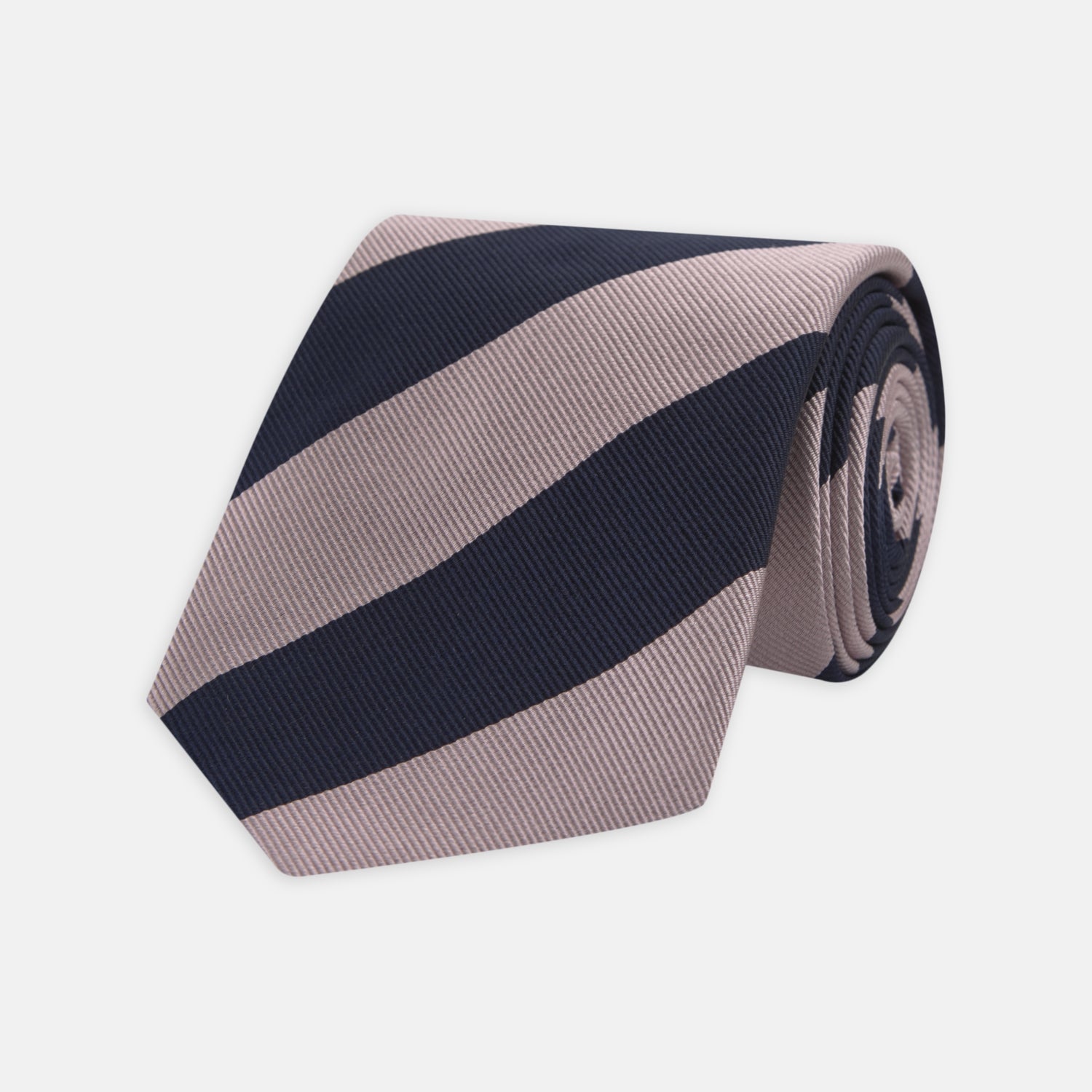 View 1 of product The Turnbull & Asser Navy and Rose Block Stripe Repp Silk Tie, crafted from luxurious silk, features bold diagonal stripes and is displayed rolled up on a plain white background.