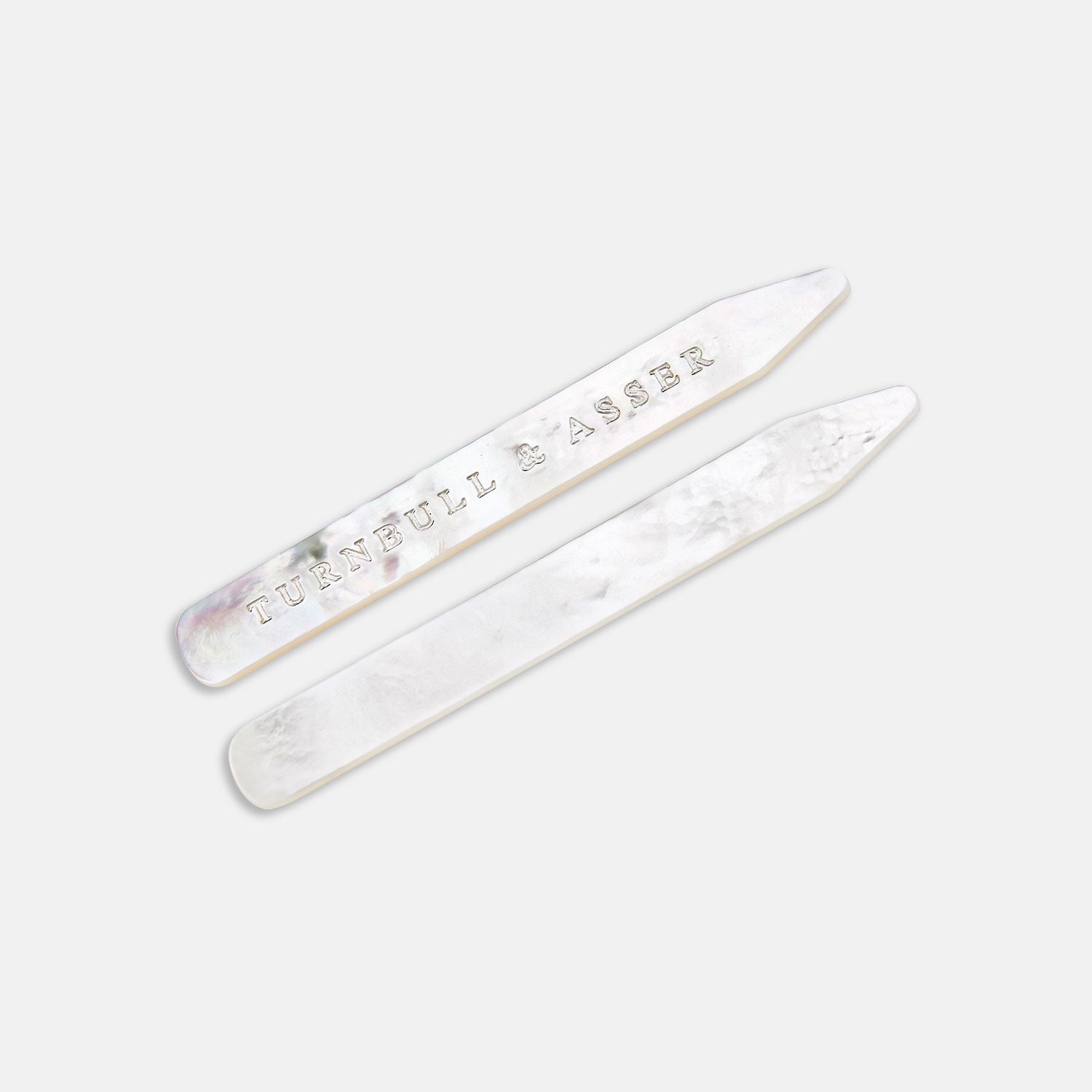 View 1 of product Two Turnbull & Asser Mother-of-Pearl Collar Stays, one engraved with the brand name, are displayed side by side on a plain light background.