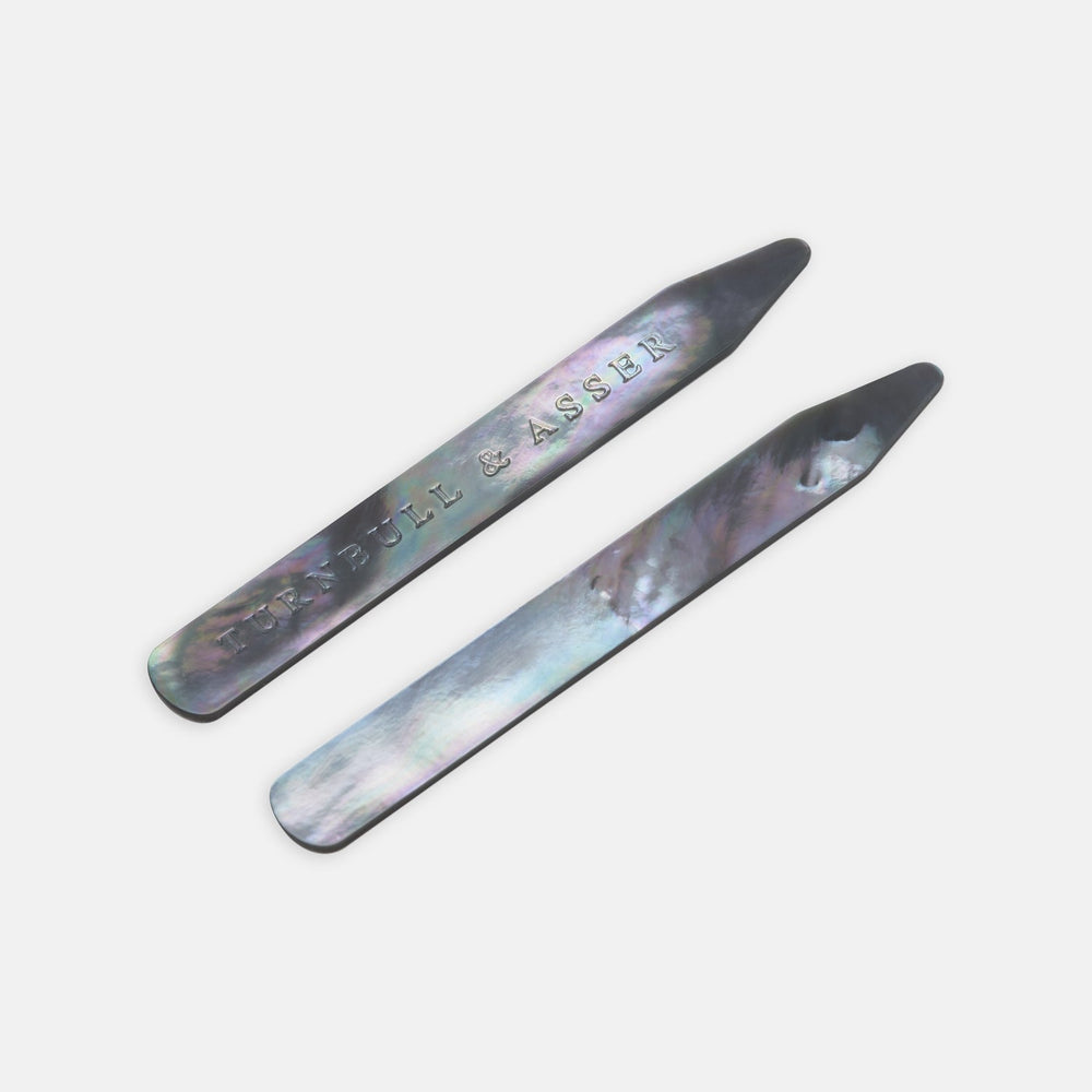 Turnbull & Asser Smoke Mother-of-Pearl Collar Stays, shown on a white background and engraved with the brand’s name, are perfect for keeping your shirt collar crisp and refined.