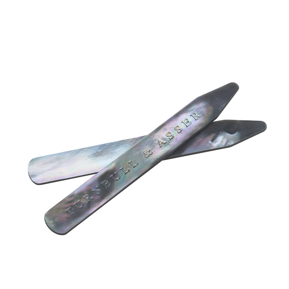 Turnbull & Asser Smoke Mother-of-Pearl Collar Stays, shown on a white background and engraved with the brand’s name, are perfect for keeping your shirt collar crisp and refined.