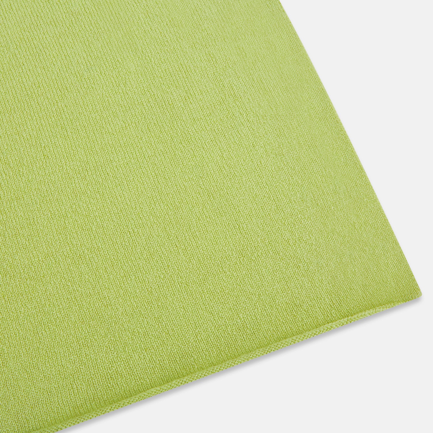 View 2 of product The Plain Canary Yellow Cashmere Knitted Scarf from Turnbull & Asser is a soft, premium accessory, elegantly draped against a white background—an essential addition to any wardrobe.