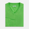 View 3 of product The Turnbull & Asser Lime Green Cashmere V-Neck Jumper features long sleeves and ribbed cuffs, hem, and neckline—ideal for adding vibrant color to your knitwear collection. Displayed on a white background.