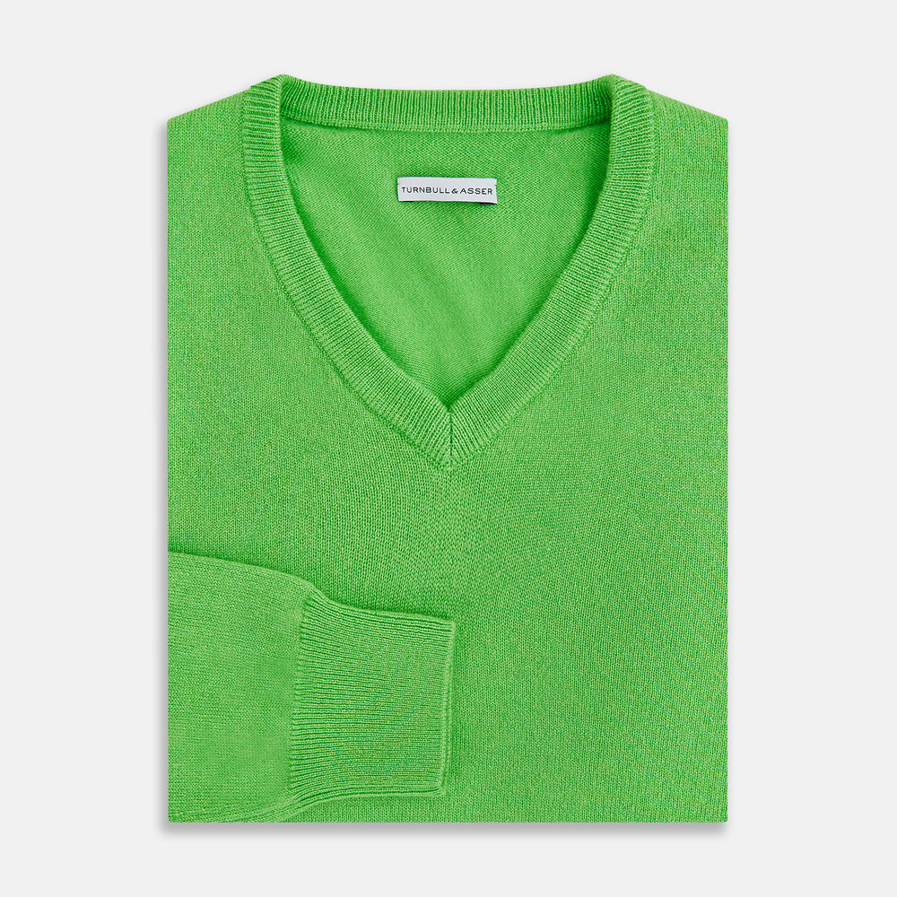 The Turnbull & Asser Lime Green Cashmere V-Neck Jumper features long sleeves and ribbed cuffs, hem, and neckline—ideal for adding vibrant color to your knitwear collection. Displayed on a white background.