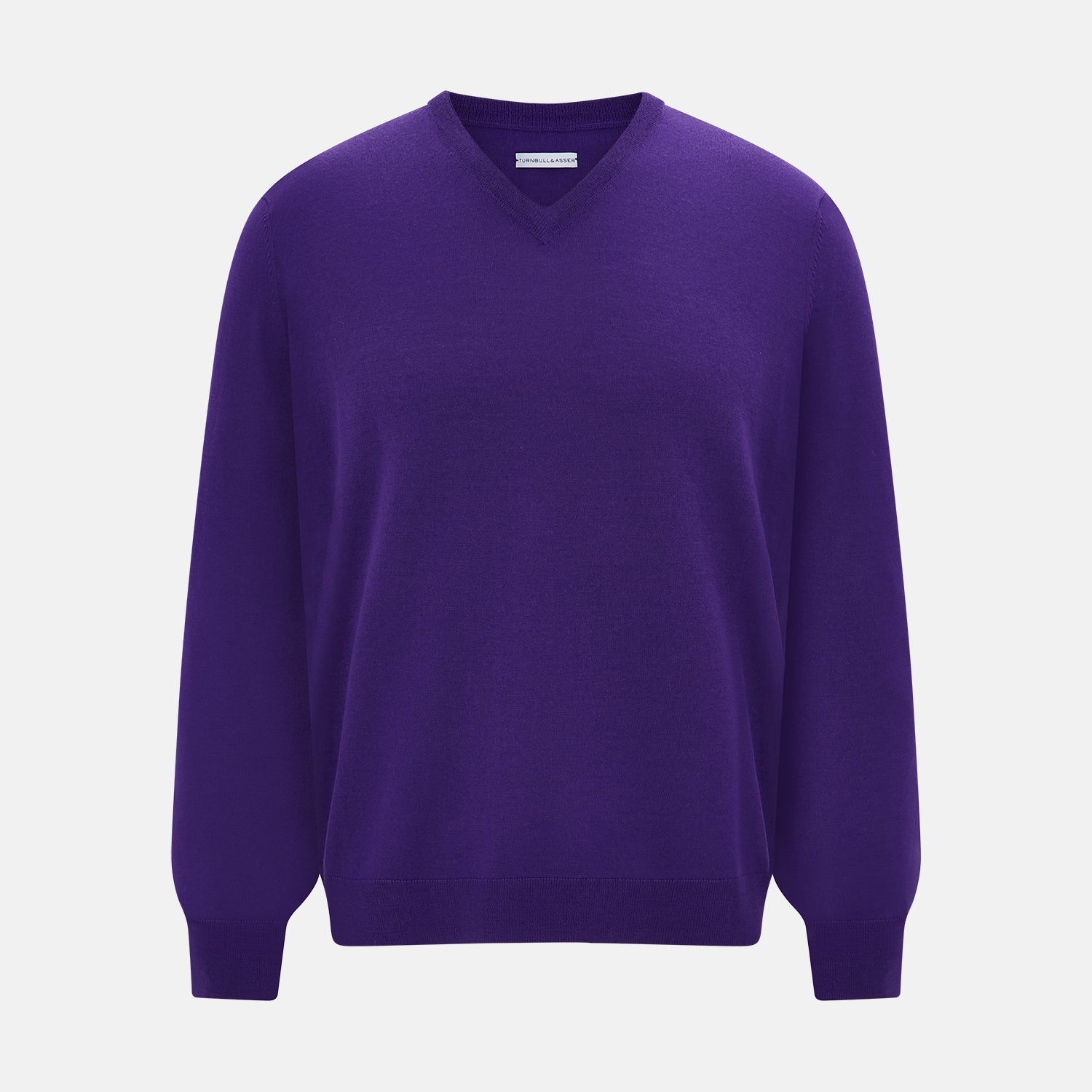 View 1 of product The Turnbull & Asser Purple Merino V-Neck Jumper features long sleeves and a rich, solid hue, making it an essential knitwear piece for any wardrobe.