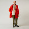 View 12 of product Wearing the Turnbull & Asser Red Walter Sealup Parka with Detachable Liner, black pants, and white sneakers, a person stands in profile against a plain light background—perfect for travel.