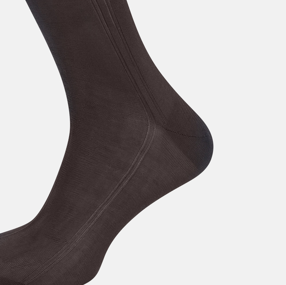 A single Sage Silk Long Sock by Turnbull & Asser, in black, is displayed from a side angle against a plain white background.