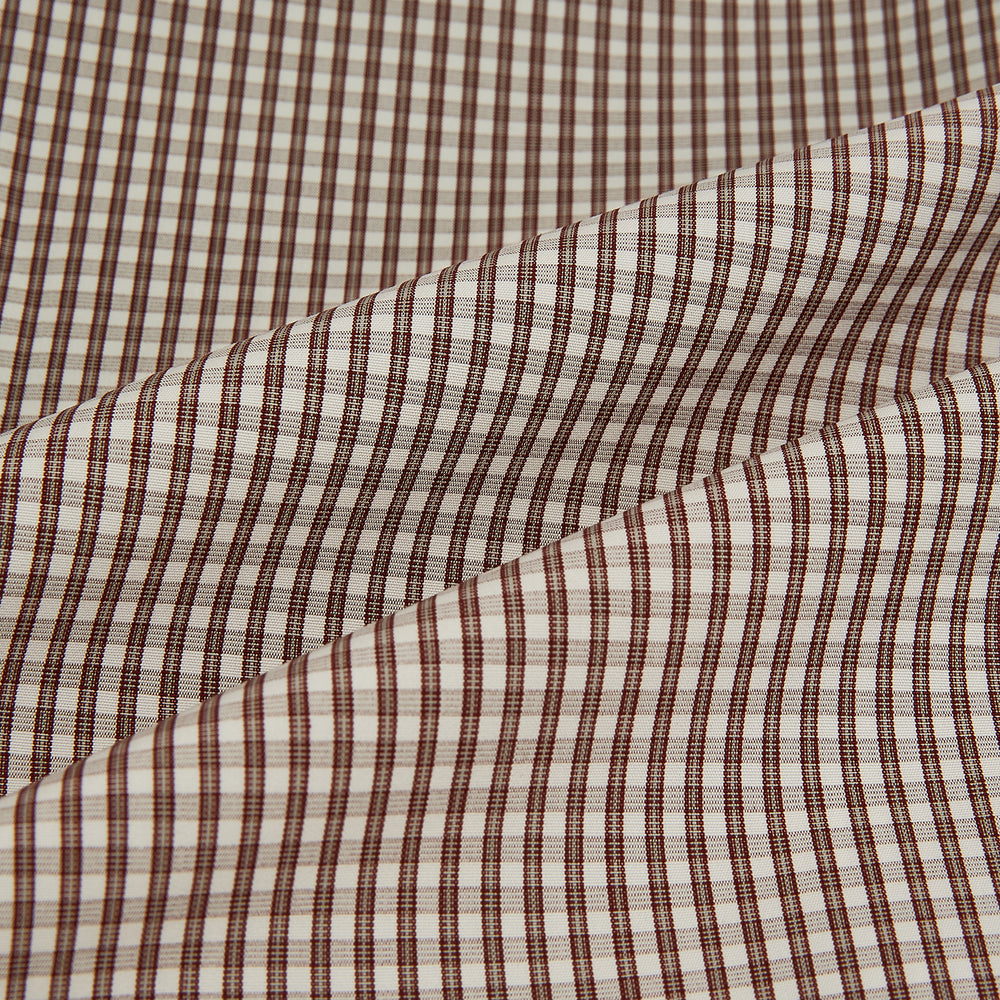 The Turnbull & Asser Burgundy Micro Check Westminster Shirt is a long-sleeved button-up with a classic collar and tailored fit, featuring a subtle micro check pattern, shown against a white background.