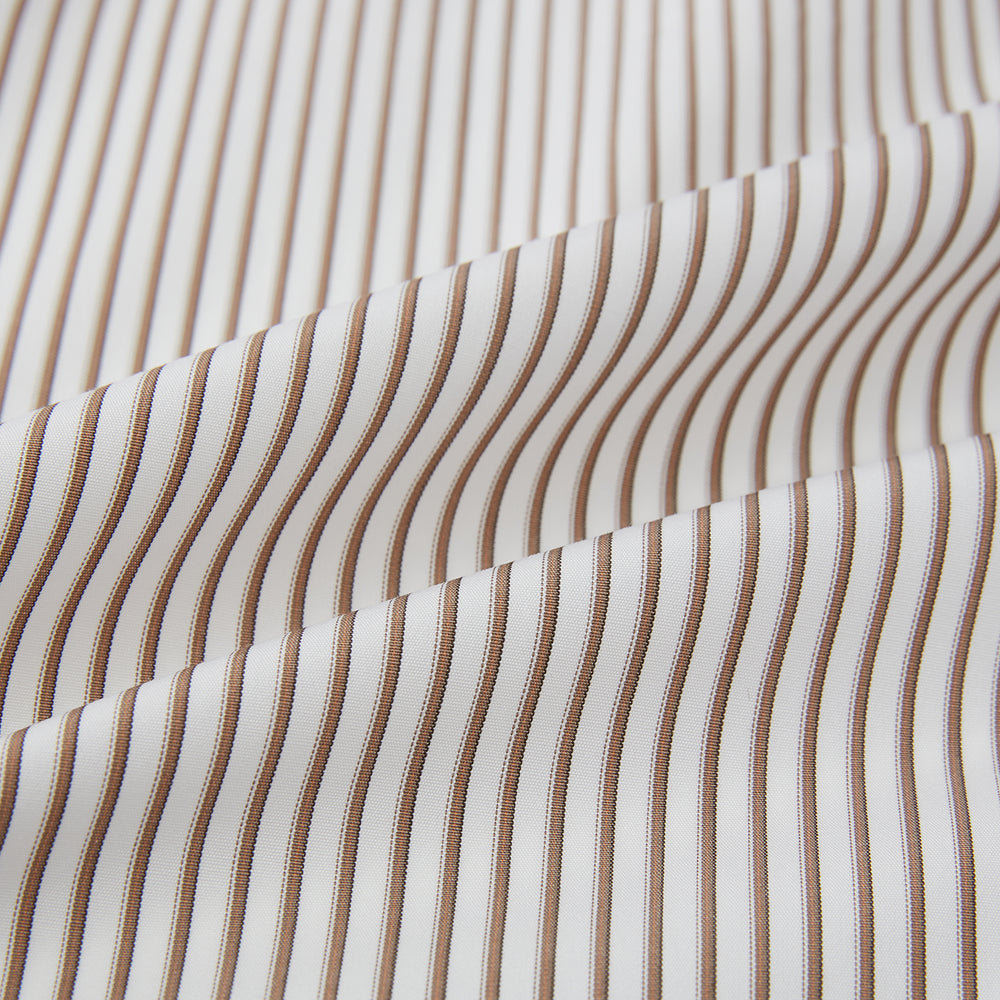 The Turnbull & Asser Coffee Multi Stripe Westminster Shirt features long sleeves, a button-up front, subtle beige and white stripes, a pointed Turnbull collar, and buttoned cuffs—expertly crafted in Britain and shown flat on a white background.