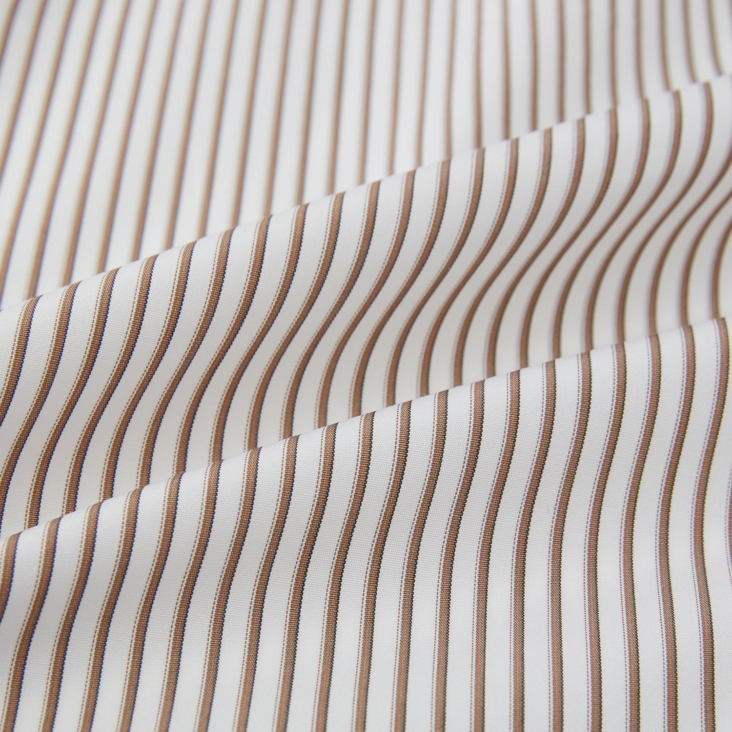 View 8 of product The Turnbull & Asser Coffee Multi Stripe Westminster Shirt features long sleeves, a button-up front, subtle beige and white stripes, a pointed Turnbull collar, and buttoned cuffs—expertly crafted in Britain and shown flat on a white background.