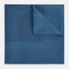 View 1 of product The Blue Dot Silk Pocket Square by Turnbull & Asser features small black polka dots on blue silk and is made in England. The image shows it neatly folded, with a corner turned down to display both sides.
