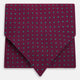 A burgundy pocket square with turquoise polka dots, folded to a point—an ideal men's formal accessory to complement the Green Micro Dot and Magenta Silk Cravat by Turnbull & Asser.