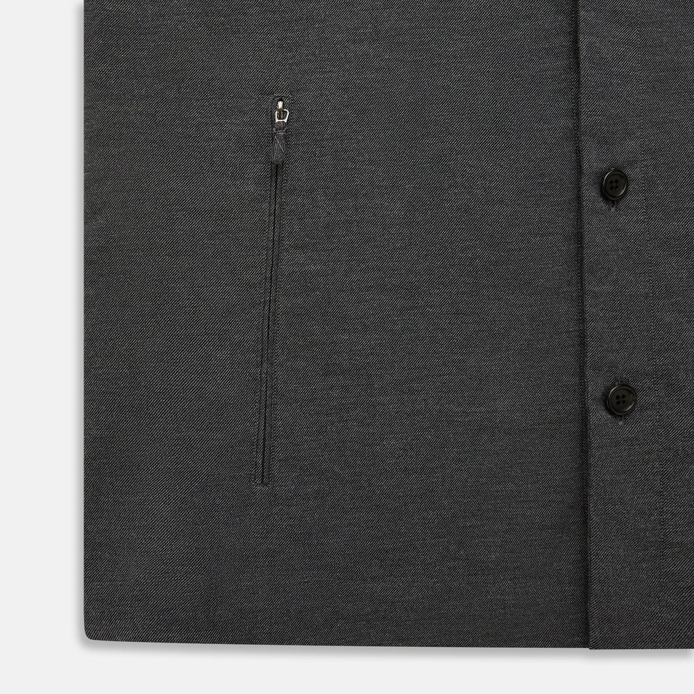 The Charcoal Melange Hampstead overshirt by Turnbull & Asser is a dark gray long-sleeve button-up with a collar, left chest pocket, and two zippered side pockets, shown laid flat on a white background.